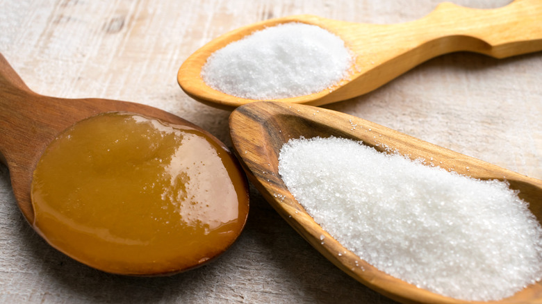 honey and sugar in wooden spoons