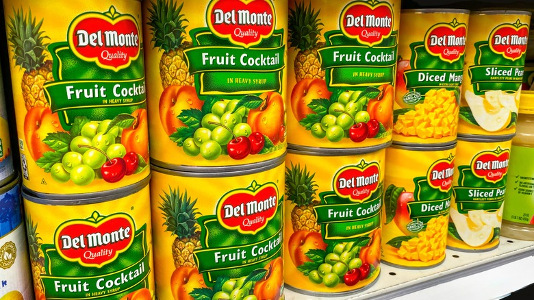 Del Monte canned fruit cocktail, mangoes and pears on a supermarket shelf