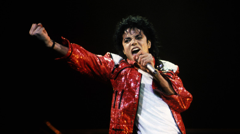 Michael Jackson performing onstage in red sequined jacket