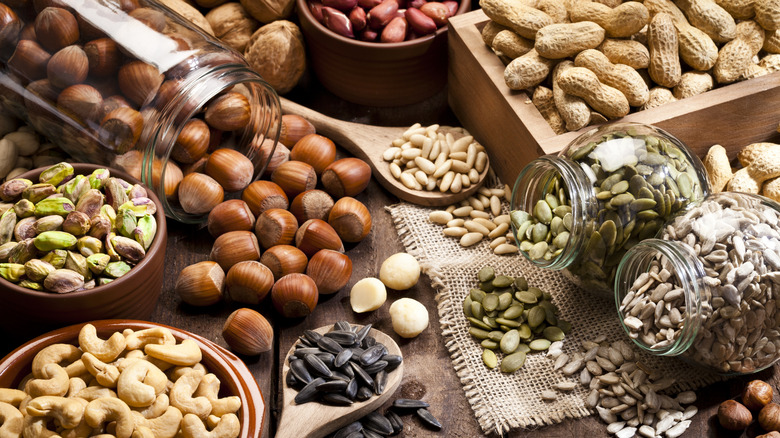 Assortment of nuts and seeds on wooden table