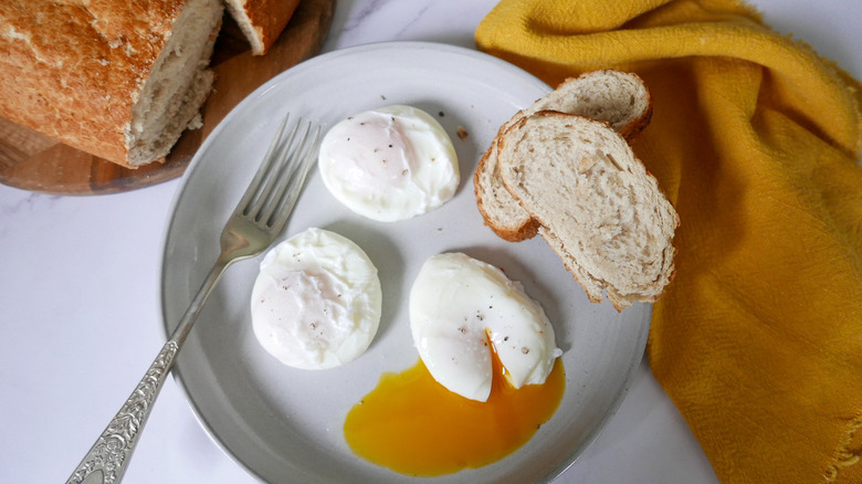 three poached eggs with bread