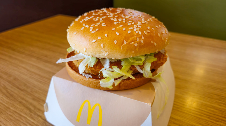 A McDonald's chicken sandwich sits on top of a takeaway box.