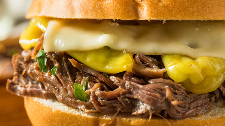Close up of shredded pot roast on a sandwich