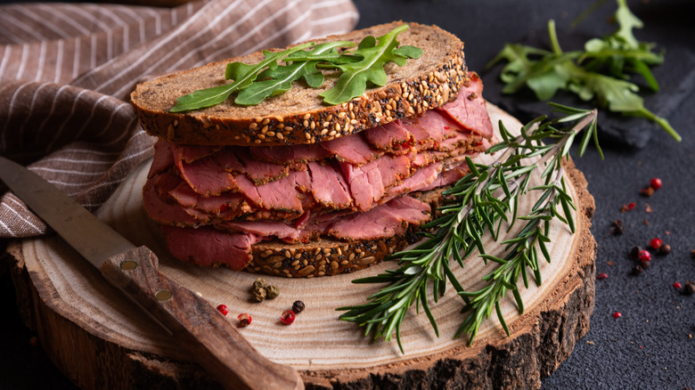A pastrami sandwich with rosemary and arugula