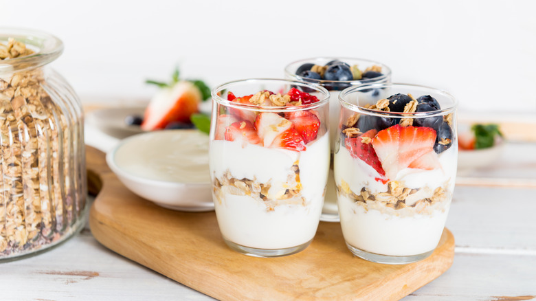 Jars of yogurt parfait with fresh berries and granola.