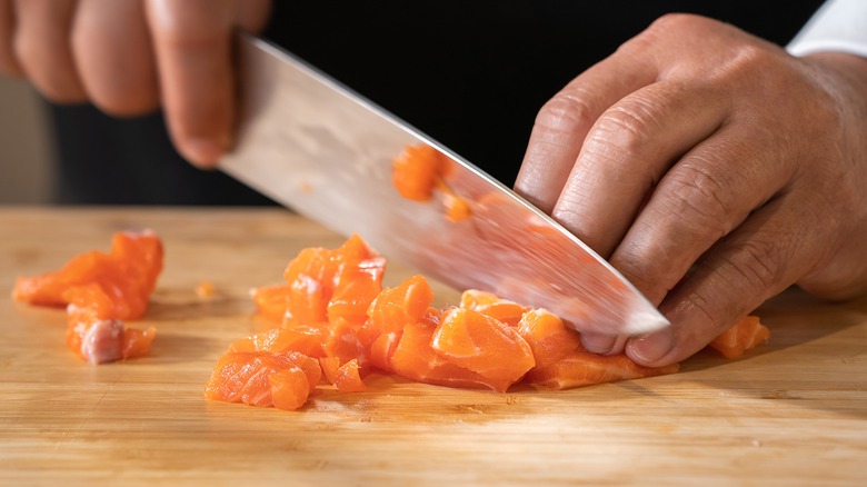 Salmon cubes being cut