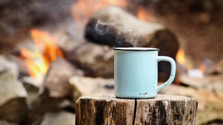 Steaming mug of coffee outdoors