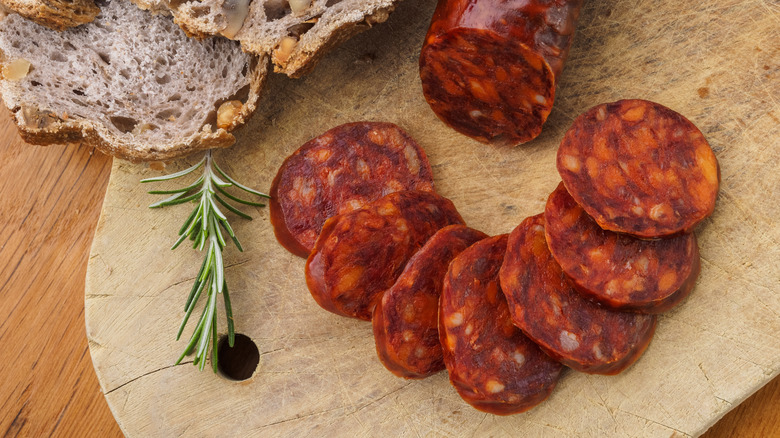 Sliced Spanish chorizo on a wooden cutting board