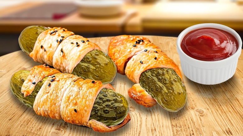 Pickles in a blanket with ketchup