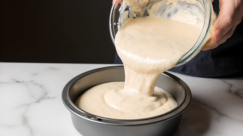 cake batter being poured into cake pan