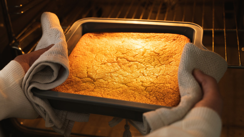 cake in a cake pan going into the oven