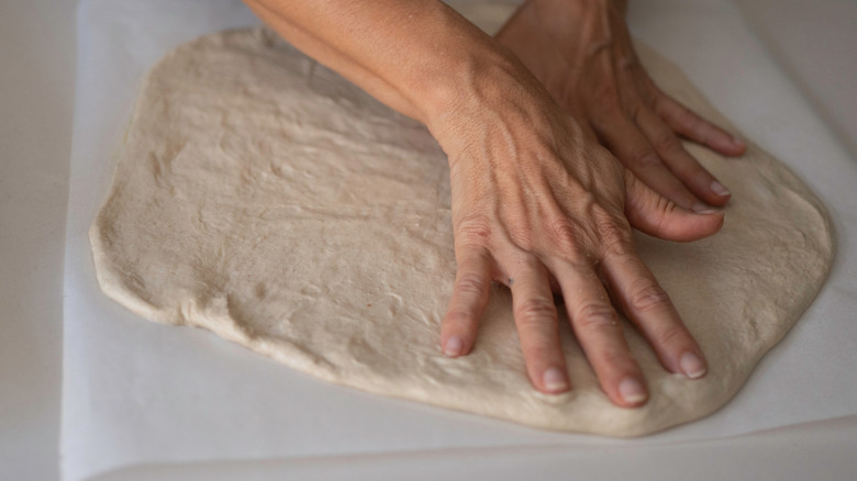 Pizza being made on parchment paper