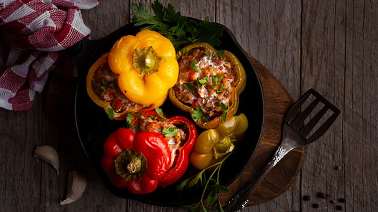 Cast iron pan of red, yellow, and green stuffed peppers