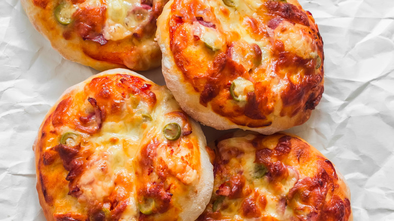 Mini biscuit pizzas on paper