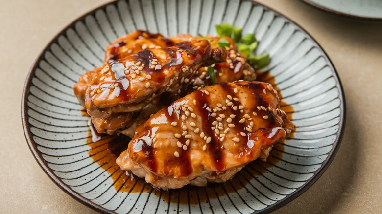 Japanese-style glazed chicken breasts on a ceramic plate