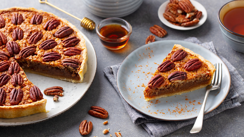 Pecan pie and slice on plate