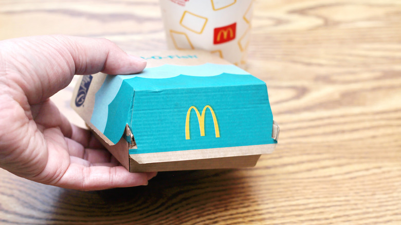 Hand holding a McDonald's Filet-O-Fish box