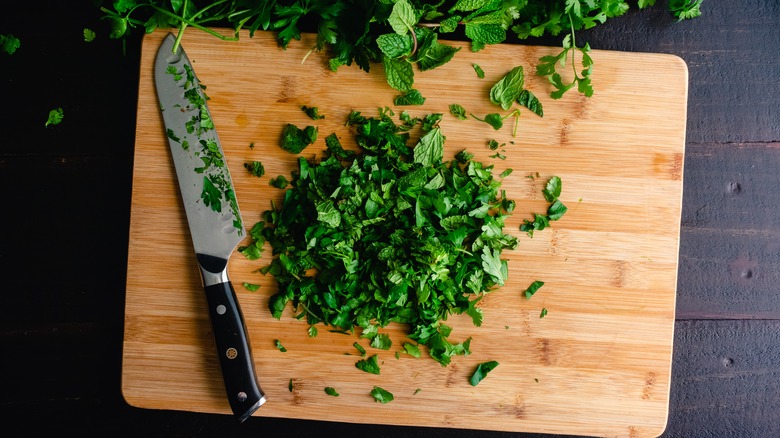 chopped herbs on cutting board