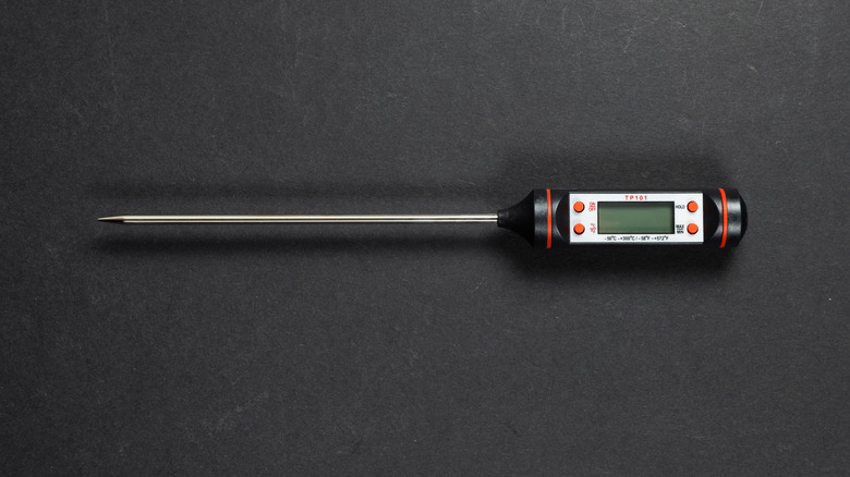 digital meat thermometer on black surface
