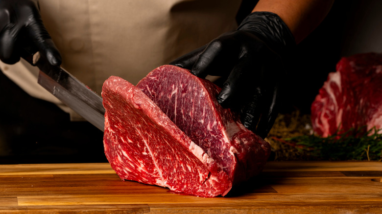 butcher cutting beef