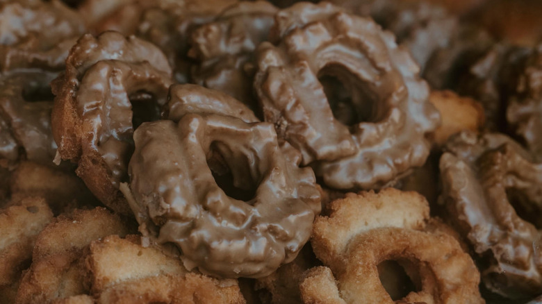 A stack of glazed old fashioned donuts on display at Bob's Donuts
