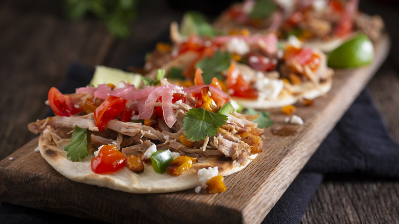 Chicken tacos with red onion garnsih