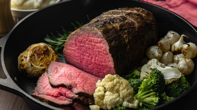 Sliced eye of round roast beef with roast vegetables