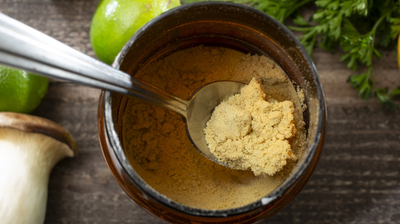 Top-view of scooping chicken bouillon with a spoon