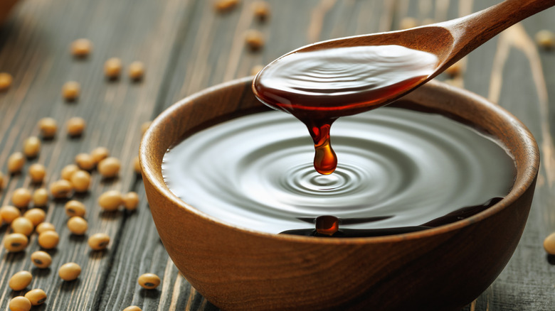 Soy sauce in a bowl with soybeans