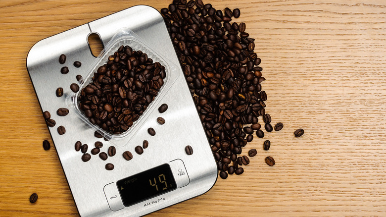 weighing coffee beans on scale