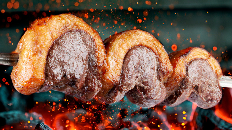 Skewered picanha beef cuts, grilling