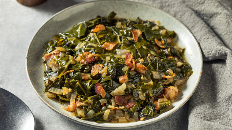 braised collard greens with pork and onion in a bowl