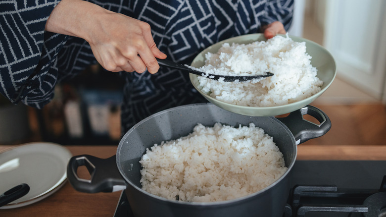 woman serving cooked white rice