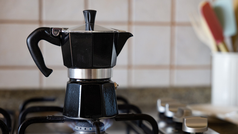 A moka pot on a gas stove