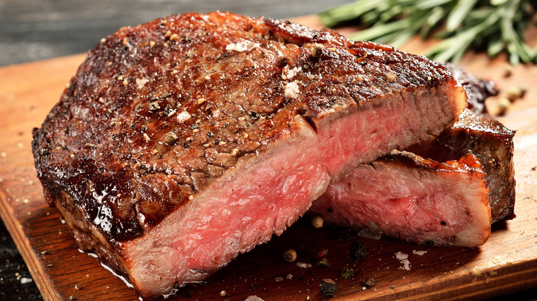 Ribeye steak on a wooden surface