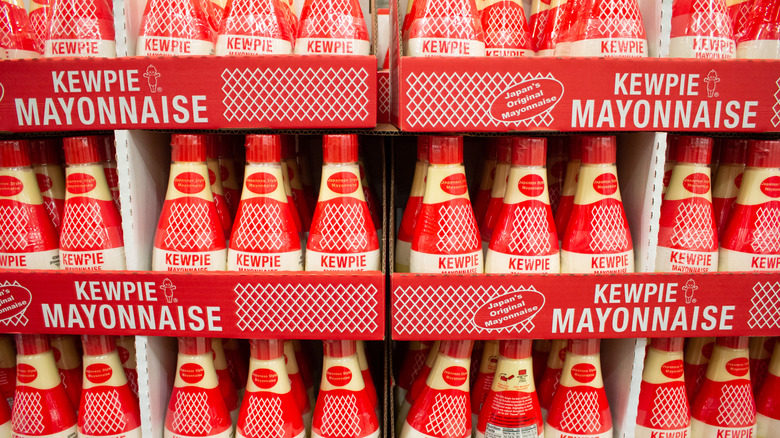 A display of Kewpie mayonnaise in classic red and clear packaging