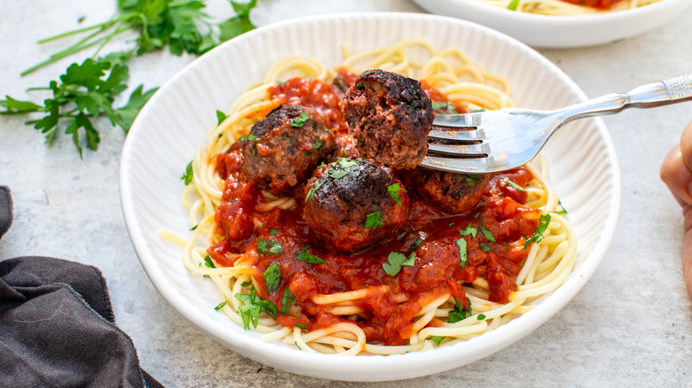 Bowl of vegetarian spaghetti and meatballs with fork