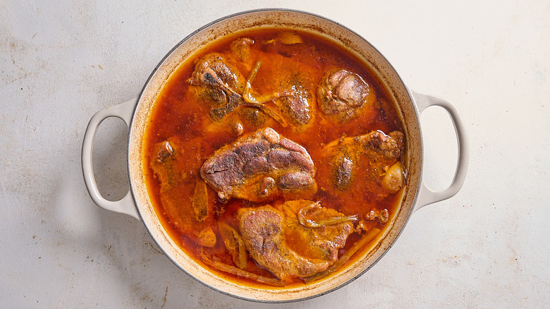 A rich pot of braised pork in gochujang braising liquid