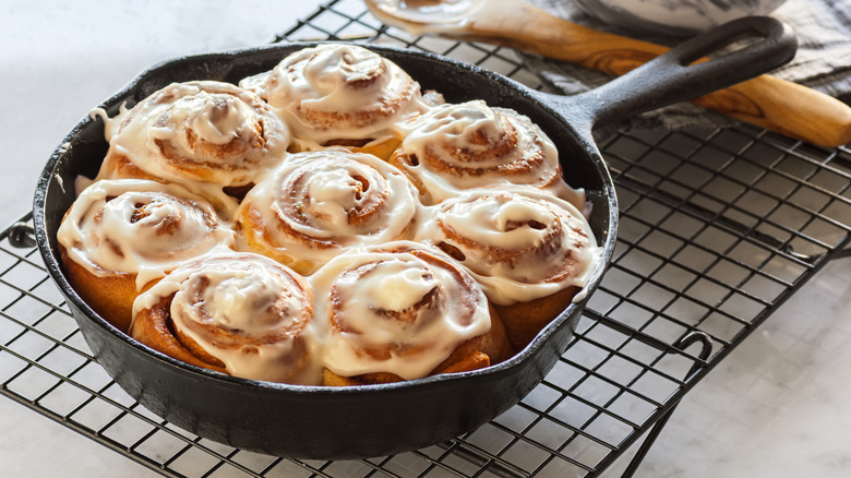 Close-up of homemade cinnamon rolls in a cast iron skillet