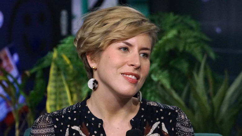 "Home Town" co-host Erin Napier at a public event, with several green plants in the background
