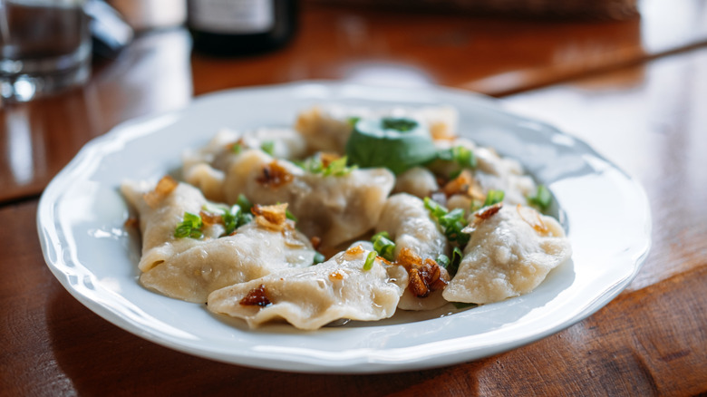 A plate of lightly brown pierogies