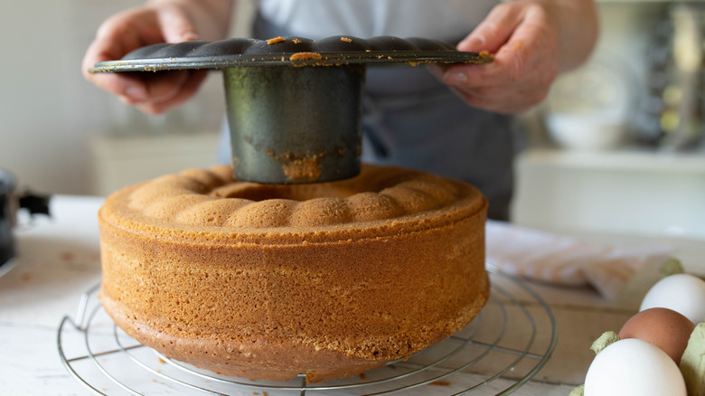 Person removing a Bundt cake from a pan