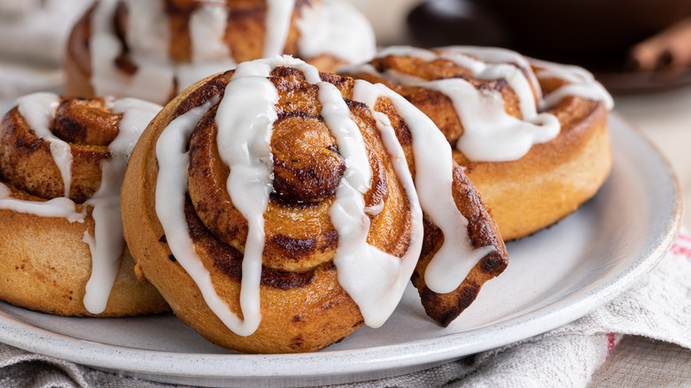 plate of frosted cinnamon rolls
