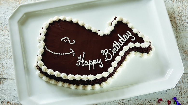 Carvel's brown Fudgie the Whale cake with 'Happy Birthday' written in white icing