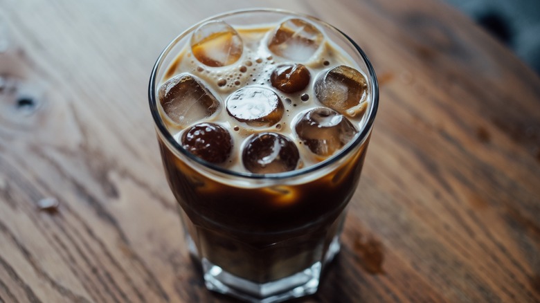 A glass of protein-packed cold brew sitting on a table