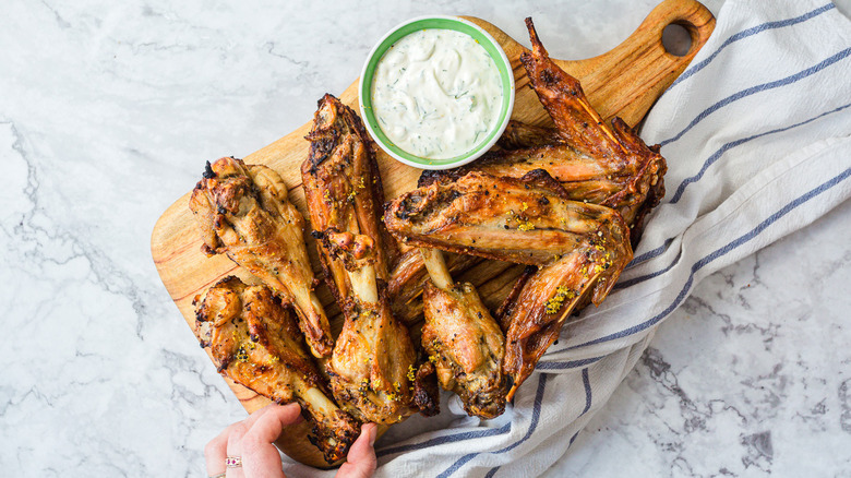 Top view of lemon pepper turkey wings served on a wooden board