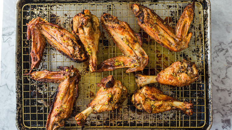 Turkey wings with lemon pepper seasoning sprinkled on them