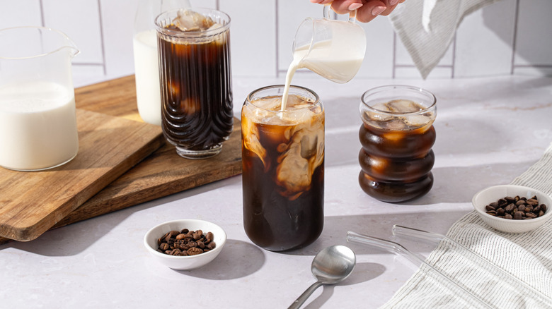 Creamer poured into iced coffee