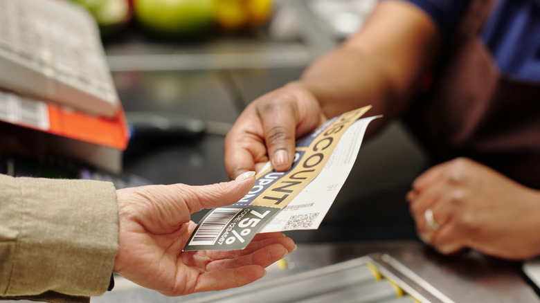 customer using coupon in grocery store