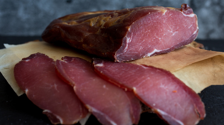 Cold-smoked meat sliced on paper bag